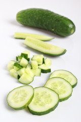 Slicied and diced cucumbers. Isolated on a white background.