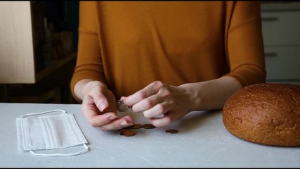 The poor woman is counting the last coins. The economic crisis. Social problem.