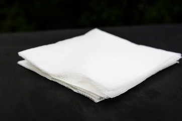 white napkins on a black background. Close-up.