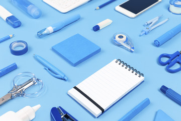 Assorted office and school white and blue stationery and smartphone background as border. Organized with copy space for back to school or education and craft concept. Blue monochrome banner