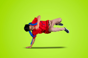 Attractive bboy break dancing in the studio