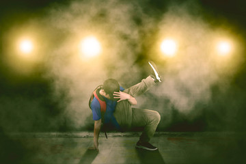 Fototapeta na wymiar Student doing break dance with smoke background