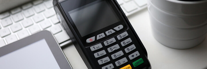 Fototapeta na wymiar Mobile POS payment terminal lie on white table closeup background
