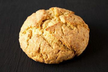 Homemade Irish Soda Bread on a black background, low angle view. Close-up.