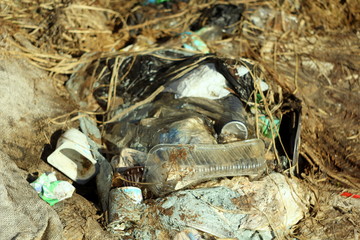 03-05-2020. Syktyvkar, Russia. Heap of garbage with bags, plastic, dry grass, cardboard and bottles.