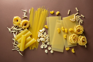 Variety of types and shapes of Italian dry pasta overhead view
