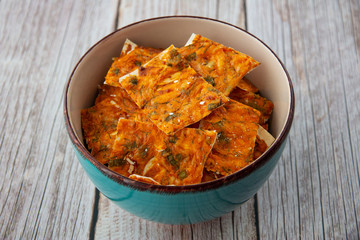 Homemade chips with cheese and herbs