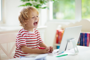 Online remote learning. School kids with computer.