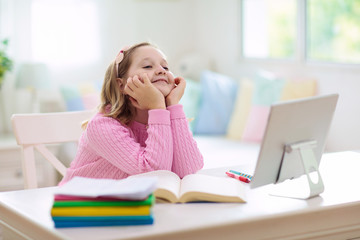 Online remote learning. School kids with computer.