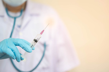 Syringe medical injection in hand holding with medicine dose vaccination equipment with needle.