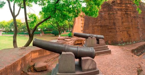 The anicent cannons (Krupp guns) in the ancient and damaged blockhouse. Those cannons were used in late 19th century.