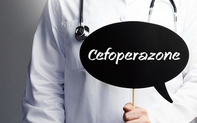 Cefoperazone. Doctor in smock holds up speech bubble. The term Cefoperazone is in the sign. Symbol of illness, health, medicine