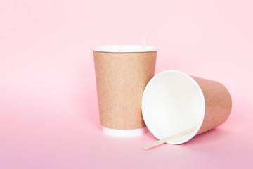 Set with disposable environmental paper utensils on pink background