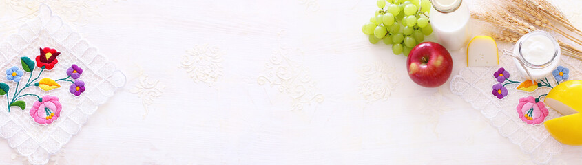 Top view photo of dairy products over white background. Symbols of jewish holiday - Shavuot