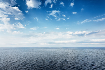 Sea landscape with blue sky and tiny clouds on a summer day.