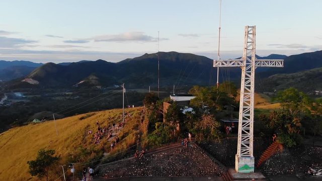 Aerial, orbit, drone shot around tourists at the viewpoint on Mount Tapyas, during sunset, on Coron island, in Philippines, Asia