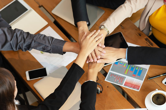Group of people united hands to built teamwork together with Spirit - teamwork concepts.