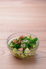 Mix salad of cucumbers, meat, tomatoes, broccoli cabbage, dill and parsley. Seasonal food with plenty of vitamins.