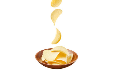 Chips in wooden plate and falling ones isolated on white background