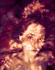 Double exposure of young woman and flowers.