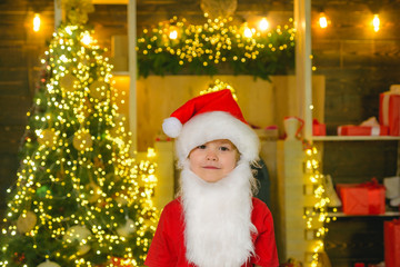 Christmas kids. Cute little kids celebrating Christmas. Portrait of Santa kid with white beard looking at camera. Happy new year.