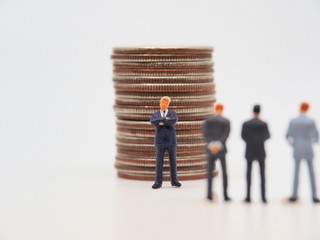 A miniature father standing in front of his sans.Inheritance concept image.