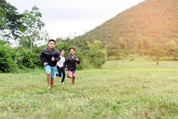 Young boy and girl running on a field