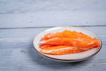 Crab sticks on the plate that is on the table