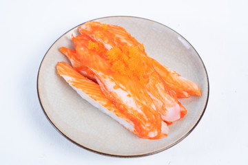 Crab sticks on the plate that is on the table