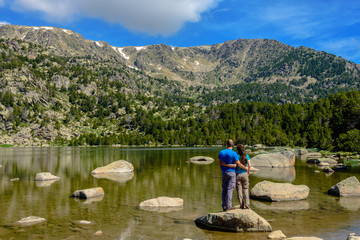 Fototapeta na wymiar Hikers couple at the Malniu Lake (Cerdanya province, Catalonia, Spain)