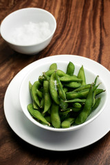 edamame beans in bowl on table with sea salt
