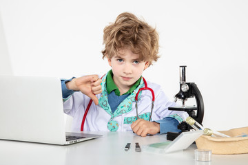 young doctor sitting over a microscope in his laboratory