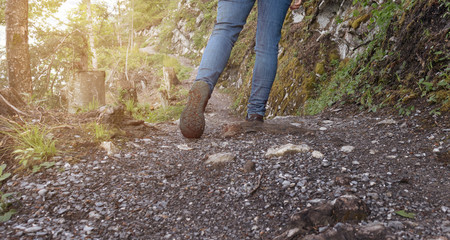 Woman hiking on forest pathway close up.