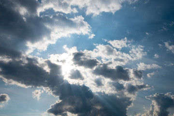 the sun's rays break through the dark, threatening clouds. The concept of faith and hope. Background, texture