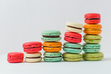 Beautiful colorful desserts. French macaroons on a white background	