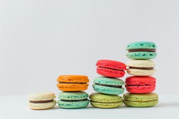 Beautiful colorful desserts. French macaroons on a white background	