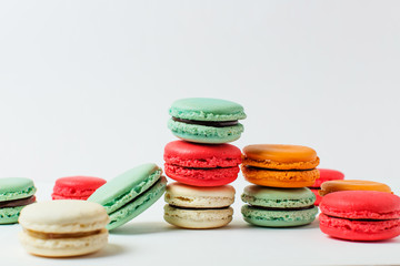 Beautiful colorful desserts. French macaroons on a white background	
