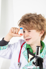 young doctor looks at the finished vaccine in the bottle