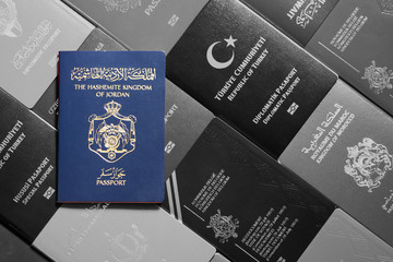 Passport of the Hashemite Kingdom of Jordan on monochrome background various passports of the world.