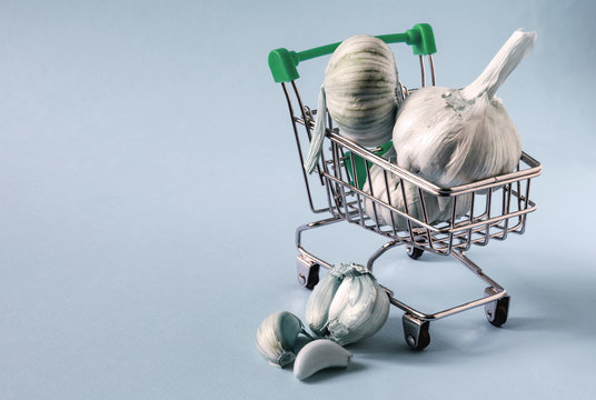 garlic bulbs in a supermarket cart on a light background close up