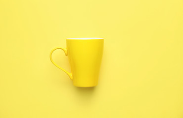Blank cup on color background