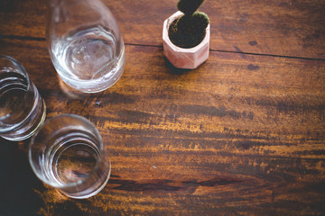 Glasses of water on a shabi wooden table. Trendy serving in the stylish hipster restaurant.