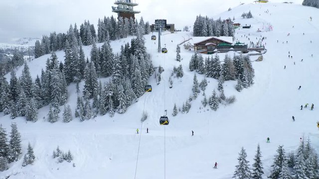 Schladming Planai Ski Resort in Austria, state of Styria, Ski Lift carry Skiers up the Mountain - Aerial View