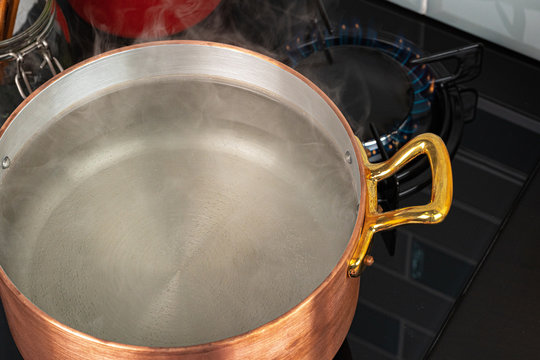 Copper Pot With Boiling Water On A Gas Stove Close Up