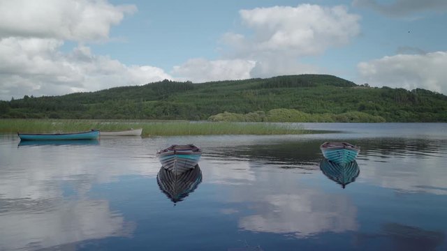 Wooden boats on a still lake 