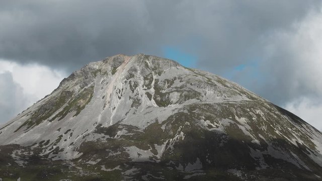 The peak of Mount Errigal in Donegal, Ireland.  Amidst cloud cover.