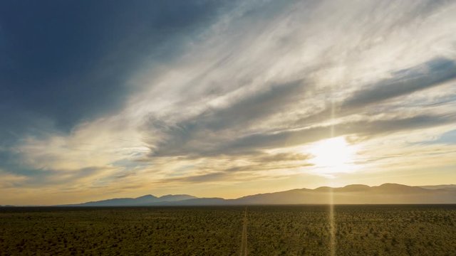 Bright Sunset Shining Through Clouds Over The Mountains And Desert In California City, USA During Summer. - hyperlapse
