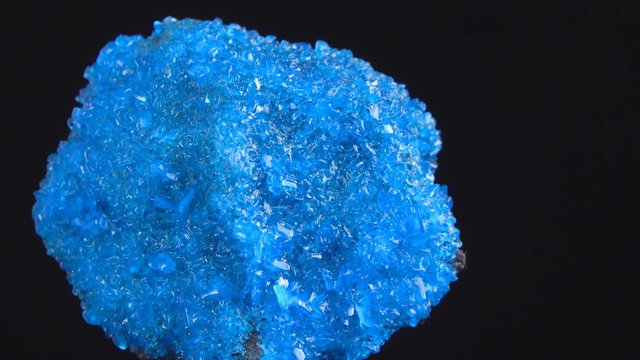Blue Covelline or Covellite Crystals slowly rotates on a black background. Copper sulfide (CuS), from Etna volcano. Mineral of volcanic origin