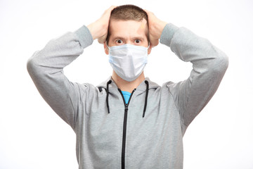 Surprised enthusiastic man athlete, with a Band-Aid on his head from the injury, grabbed both hands on the head with delight, in sports clothes, looking at the camera. Close-up, isolated