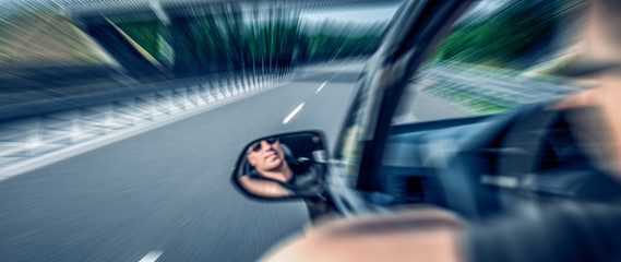 Driver drives a car. Motion blur background.